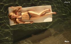 amber heard laying on  water with bikini