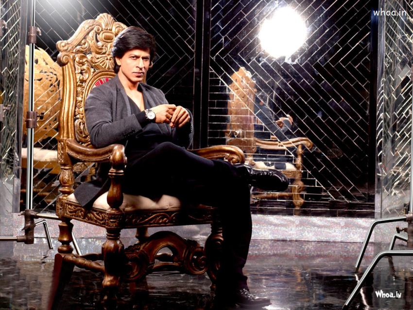 Shahrukh Khan Sitting On A Chair With Black Suit