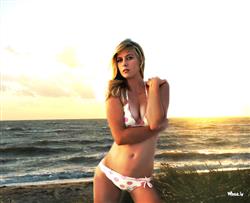 maria sharapova in a pink and white bikini on a beach