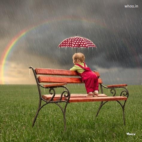 Small Child Watching A Colorful Rainbow