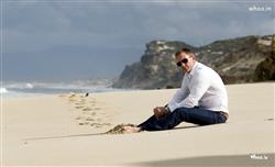Daniel Craig Setting on the Beach with Black Sunglass