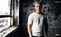 Daniel Craig with Black and White Old Cottage Background