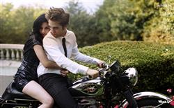 Robert Pattinson and Kristen Stewart Drive a Bike with Natural Background