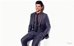 Taylor Lautner Blue Suit and Setting on White Chair