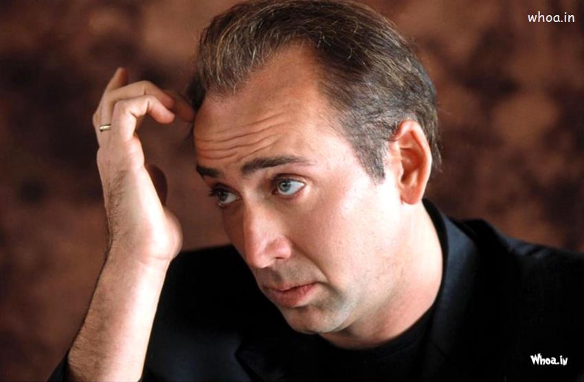 Nicolas Cage Black Suit With Brown Background