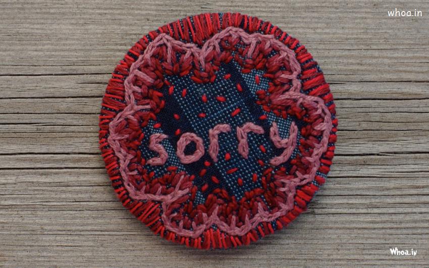 Sorry Written In Embroidery Work HD Wallpaper