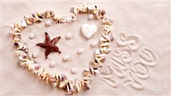A beautiful massage I miss you is wrote on a see sand with star fish, pearl and stones