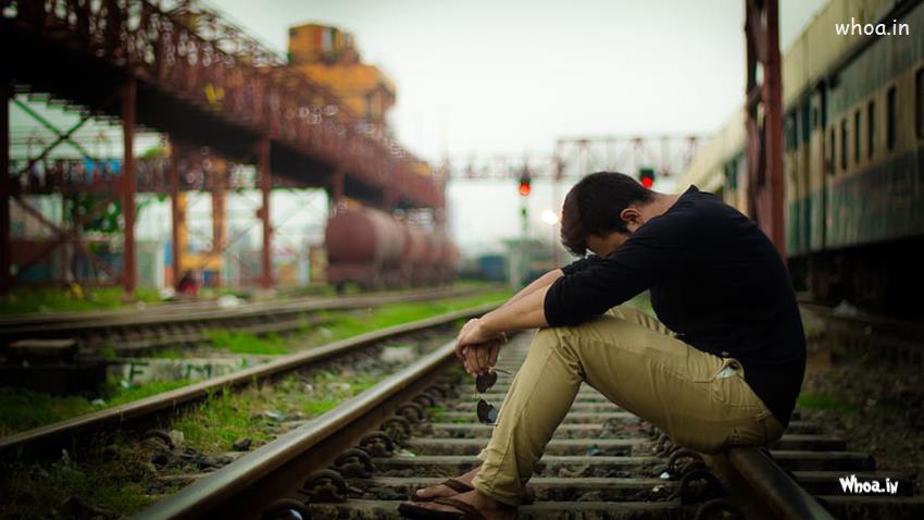 Best Sad Looking Man Sitting Alone On Railway Track HD Image