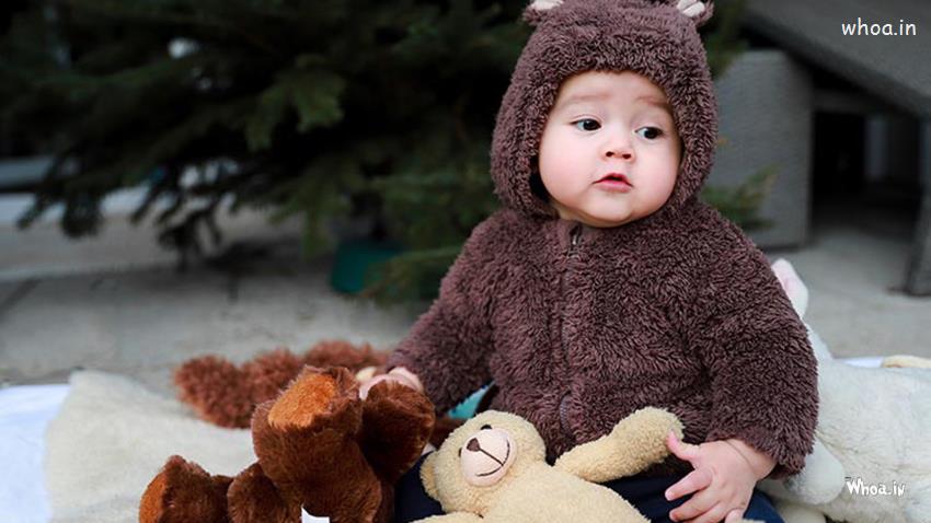 Cutebaby Wearing Brown Woolen Knitted Dress Sitting With Toy